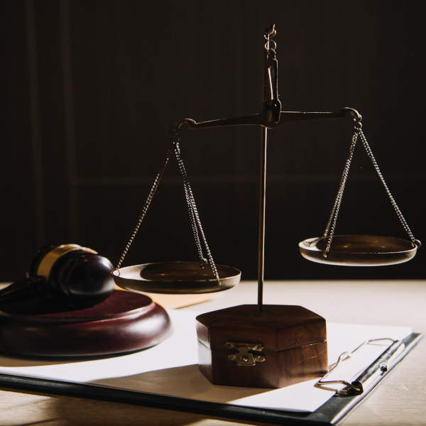 Scales of Justice with gavel and clipboard with papers